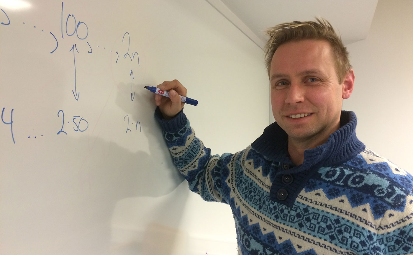 Tom Rune Kongelf foran whiteboard med utregninger